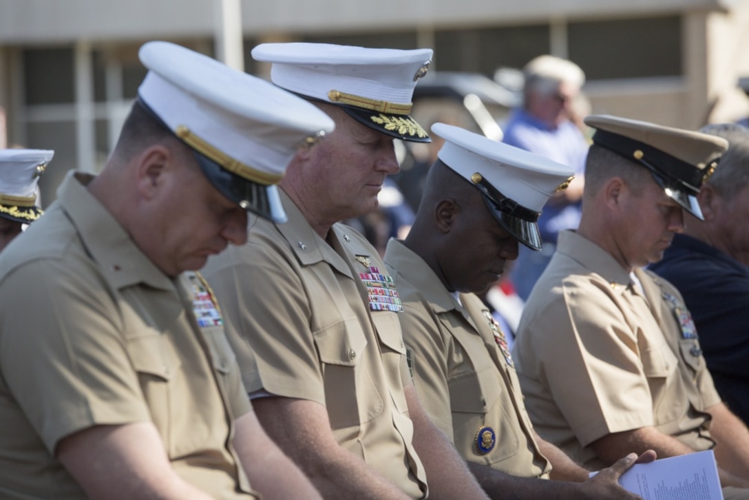 (Left to right) Chief Warrent Officer 5 Edward Brantley, the aide de camp of 4th Marine Aircraft Wing, Marine Forces Reserve, Brig. Gen. Bradley James, commanding general of 4th MAW, MARFORRES, Sgt. Maj. Rodney Lane, sergeant major of 4th MAW, MARFORRES, and Master Chief Petty Officer Jeffrey Pritchett, command master chief of 4th MAW, MARFORRES, bow their heads during a moment of silence at a memorial for the 16 fallen service members who died in a C-130 crash on July 10, 2017, in Moorhead, Miss., Oct. 19, 2017. 4th MAW leaders and Moorhead residents attended the event to pay tribute to not only those that died, but to also celebrate the 200th birthday of the state of Mississippi. (U.S. Marine Corps photo by Cpl. Dallas Johnson)