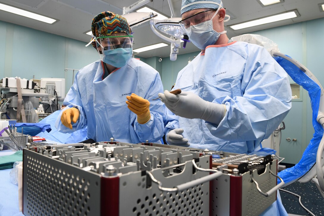 Sailors prepare for a surgical operation in an operating room aboard the hospital ship USNS Comfort.