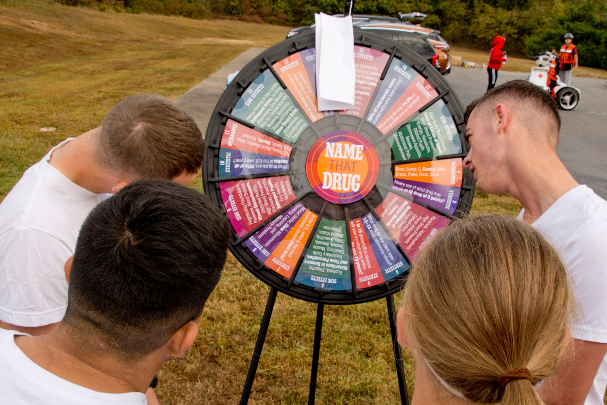 Runners test their knowledge at the “Name That Drug” wheel before the 5K Color Run at Little Rock Air Force Base, Ark., Oct. 20, 2017.