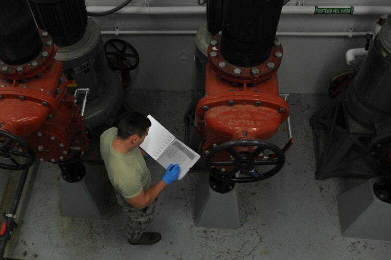 U.S. Air Force Airman 1st Class Jacob Hull, a 354th Civil Engineer Squadron waste water plant operator, records gauge readings on a clipboard Oct. 19, 2017, at Eielson Air Force Base, Alaska. Hull reads and records water pressure levels throughout the plant to ensure the equipment is working properly. (U.S. Air Force photo by Airman 1st Class Eric M. Fisher)
