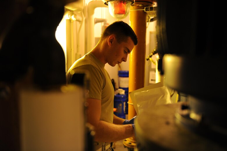 U.S. Air Force Airman 1st Class Jacob Hull, a 354th Civil Engineer Squadron waste water plant operator, records gauge readings on a clipboard Oct. 19, 2017, at Eielson Air Force Base, Alaska. Hull read and recorded temperature and pressure gauges in the plant to ensure the equipment is working properly. (U.S. Air Force photo by Airman 1st Class Eric M. Fisher)