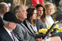 Joseph Spadavecchia (second from left), father of Brig. Gen. Kris A. Belanger, looks at a plaque of appreciation he received during his daughter’s Assumption of Command ceremony at the 85th Support Command headquarters, October 21, 2017.
