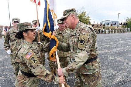 Army Reserve Brig. Gen. Kris A. Belanger, left, Commanding General, 85th Support Command, takes the command Colors from Maj. Gen. Scottie D. Carpenter, Deputy Commanding General, U.S. Army Reserve Command in an Assumption of Command ceremony at the 85th SPT CMD headquarters, October 21, 2017.