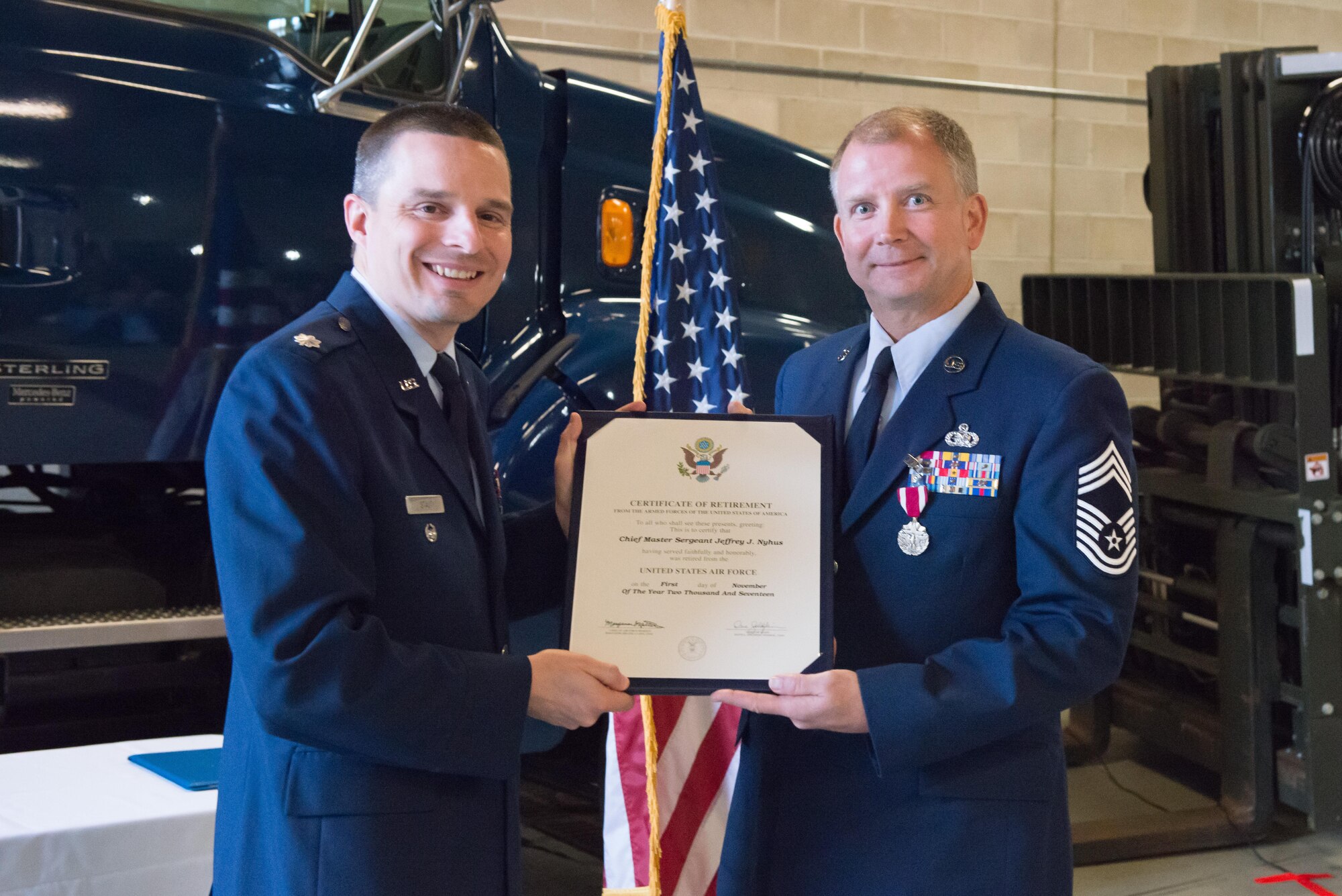 Chief Master Sgt. Jeff Nyhus receives his retiremtent certificate from Lt. Col. Andrew Staut, 934th Maintenance Group deputy commander, during his retirement ceremony Oct. 14. (Air Force Photo/Master Sgt. Eric Amidon)