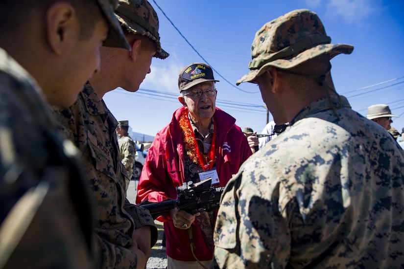 Louie Lepore, a veteran of the 5th Marine Division and Iwo Jima, talks to Marines from the 2nd Battalion, 3rd Marines, during a visit to Pohakuloa Training Area, Hawaii, Oct. 20, 2017. The veterans visited the training area as part of the 68th annual reunion of the 5th Marine Division Association and viewed weapons and equipment used by today’s Marines. Marine Corps photo by Sgt. Ricky Gomez