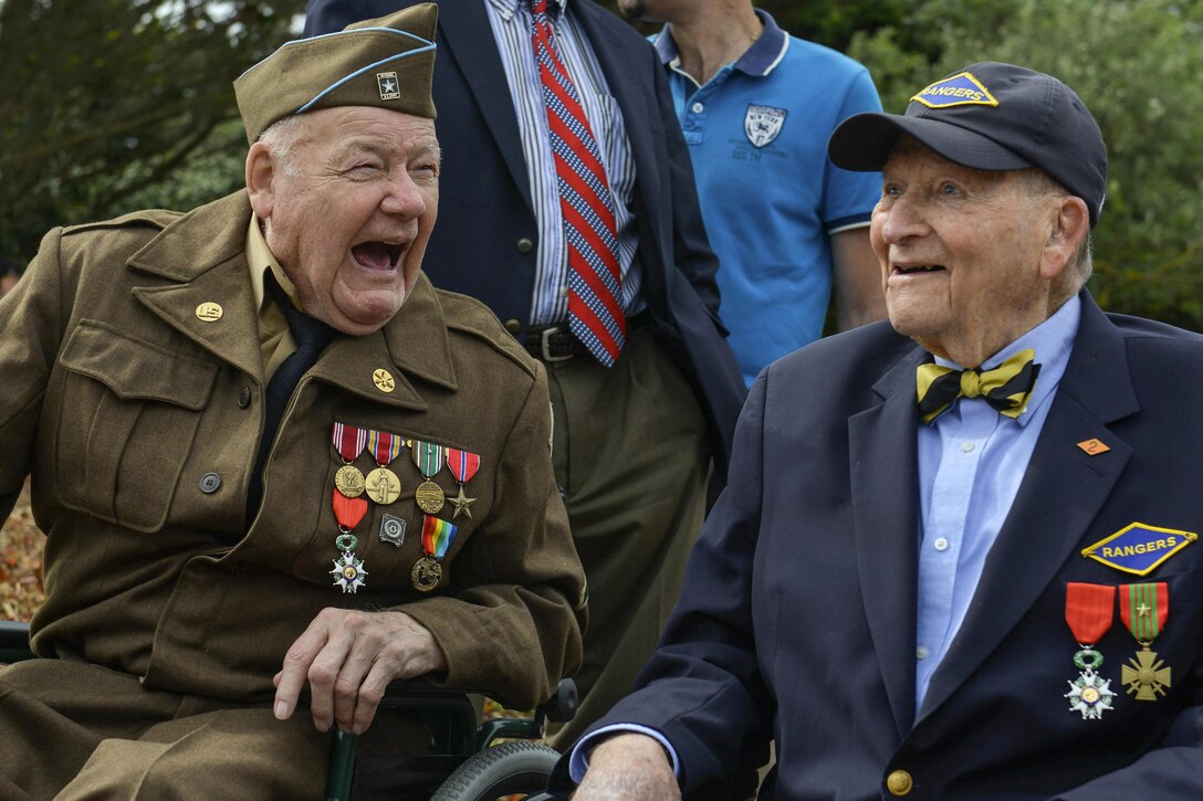 Two D-Day veterans laugh together.
