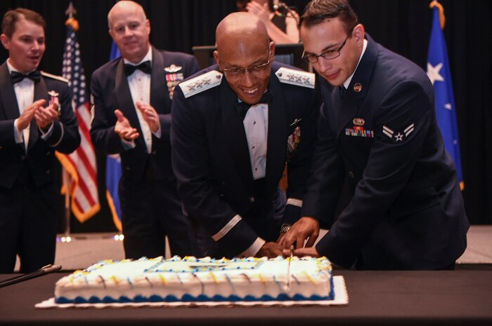 Lt. Gen. Charles Brown, U.S. Central Command deputy commander, cuts the Air Force birthday cake with Airman 1st Class Geremy Velez-Masini, 628th Logistics Readiness Squadron distribution fuels operator, during the Air Force Ball in the Charleston Area Convention Center in North Charleston, S.C., Oct. 21, 2017.