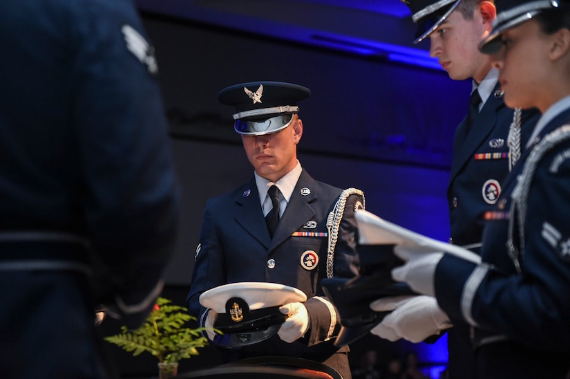 Airman 1st Class Joshua Maund, 628th Force Support Squadron Honor Guard member, presents the Navy service cover at the Prisoner of War, Missing in Action table at the Air Force Ball in the Charleston Area Convention Center in North Charleston, S.C., Oct. 21, 2017.