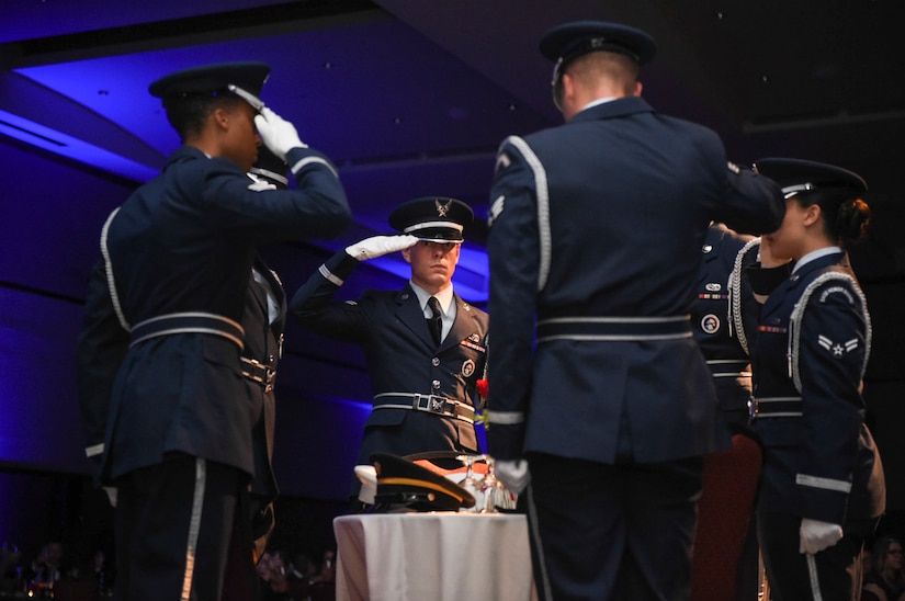 628th Force Support Squadron Honor Guardsmen salute the Prisoner of War, Missing in Action table at the Air Force Ball in the Charleston Area Convention Center in North Charleston, S.C., Oct. 21, 2017.