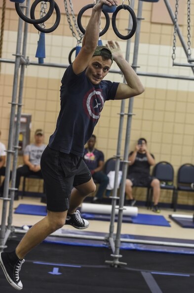 U.S. Air Force Airman 1st Class Trevor Puerile, 633rd Security Forces Squadron installation entry controller, swings across the Battle Rig hanging spheres during the Alpha Warrior Northeast Regional Competition at Joint Base Langley-Eustis, Va., Oct. 21, 2017.