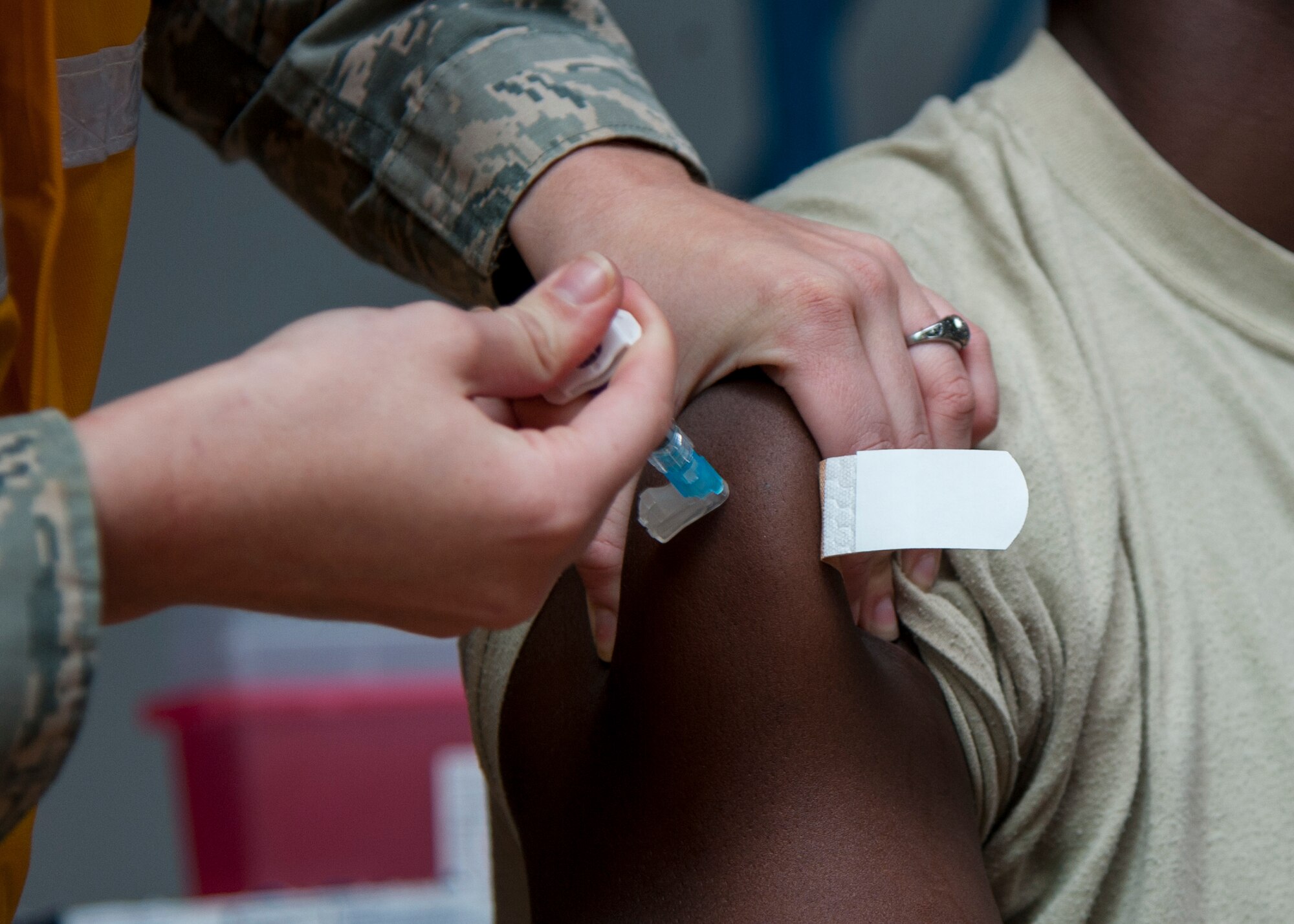 An Airman receives the influenza vaccination at Kirtland Air Force Base, N.M., Oct. 24. Flu vaccines do not contain live flu virus and are mandatory for all military members. (U.S. Air Force photo by Staff Sgt. J.D. Strong II)