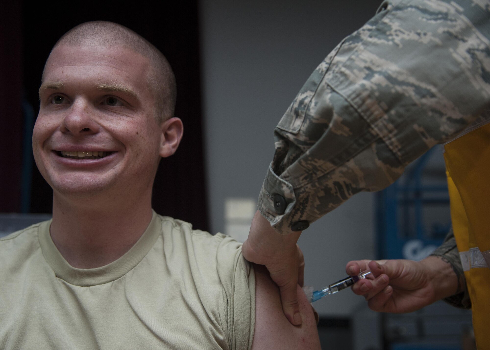 U.S. Air Force Staff Sgt. Noah Dudley, 377th Logistics Readiness Squadron vehicle operator, receives the flu vaccination at Kirtland Air Force Base, N.M., Oct. 24. It takes two weeks for protection to develop after vaccination. (U.S. Air Force photo by Staff Sgt. J.D. Strong II)