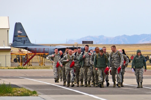 Members of the 219th RED HORSE Squadron of the Montana Air National Guard prepare to board a 120th Airlift Wing C-130 Hercules transport aircraft in Great Falls, Mont., Oct. 11, 2017. The heavy construction specialists deployed to the United States territory of Puerto Rico to assist with Hurricane Maria relief efforts. (U.S. Air National Guard photo/Senior Master Sgt. Eric Peterson)
