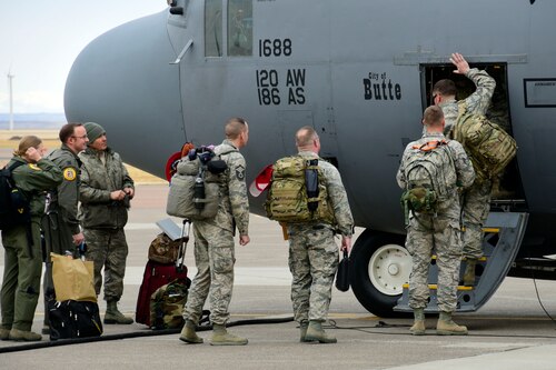 Members of the 219th RED HORSE Squadron of the Montana Air National Guard board a 120th Airlift Wing C-130 Hercules transport aircraft in Great Falls, Mont., Oct. 11, 2017. The heavy construction specialists deployed to the United States territory of Puerto Rico to assist with Hurricane Maria relief efforts. (U.S. Air National Guard photo/Senior Master Sgt. Eric Peterson)