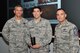 U.S. Air Force Capt. John Kauderman, 20th Aerospace Medicine Squadron optometrist, center, is recognized as Shaw “Weasel of the Week” by Col. Daniel Lasica, 20th Fighter Wing (FW) commander, left, and Chief Master Sgt. Daniel Hoglund, 20th FW command chief, at Shaw Air Force Base, S.C., Oct. 25, 2017