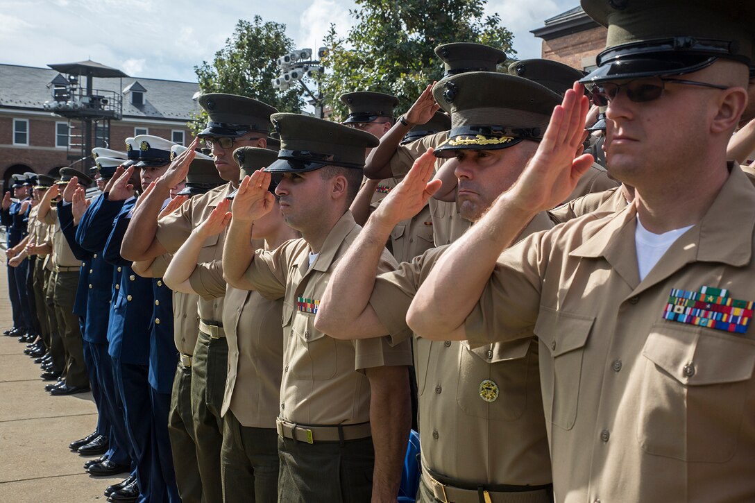 United States service members render salutes for the passing of the Colors during a Beirut Memorial Parade at Marine Barracks Washington D.C., Oct. 23, 2017. The ceremony was conducted to honor the 34th anniversary of the attack on the U.S. and French Barracks in Beirut and remember the fallen service members, and survivors and their families. (Official Marine Corps photo by Cpl. Robert Knapp/Released)