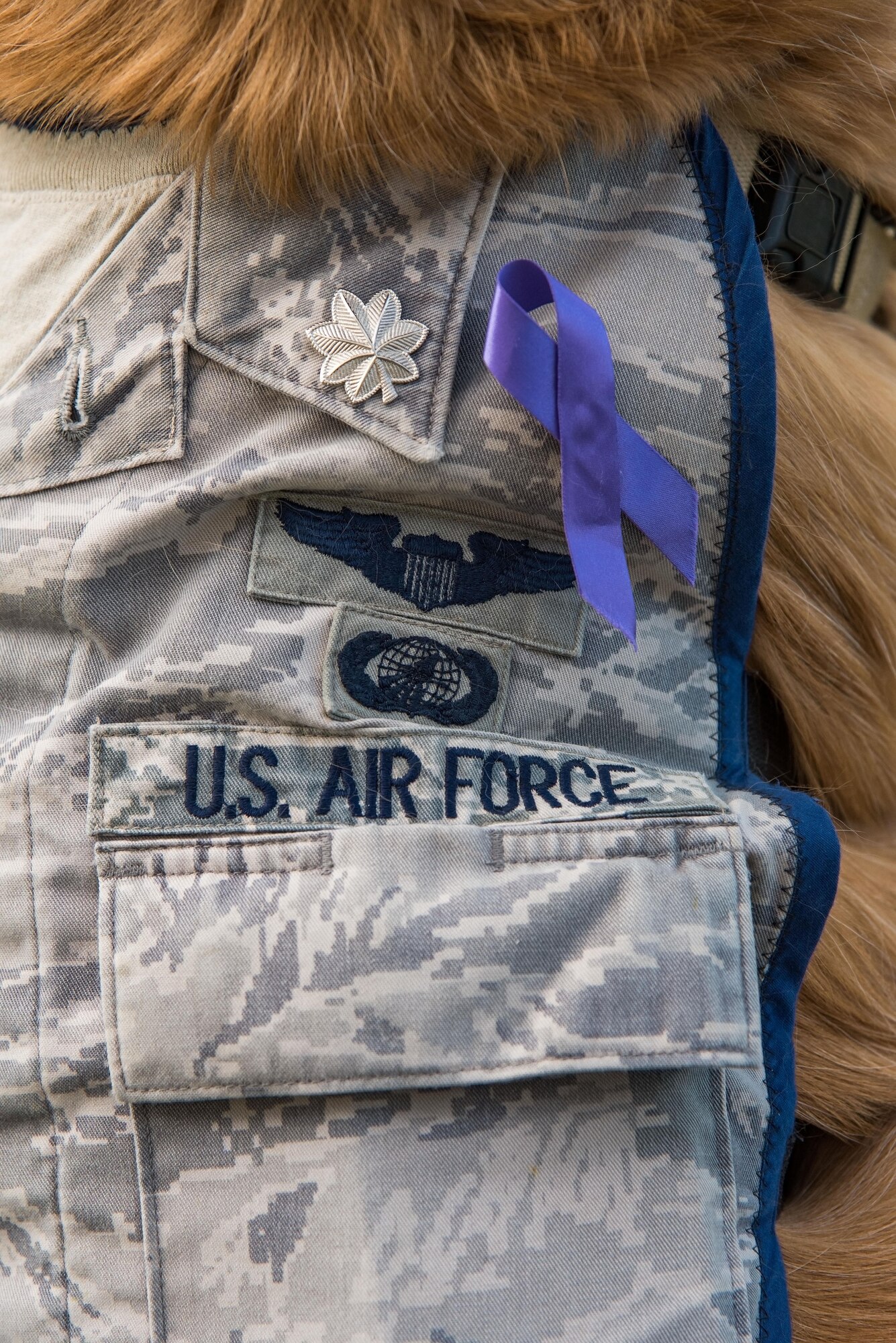 Lt. Col. Goldie wears his custom-made Airman Battle Uniform vest donning silver oak leaf clusters, Oct. 19, 2017, on Dover Air Force Base, Del. Goldie was promoted to his current rank by the Air Force Thunderbirds in September during the 2017 Joint Base Andrews, Md., air show. The purple ribbon worn on his ABU vest is in support of Domestic Violence Awareness Month. (U.S. Air Force photo by Roland Balik)