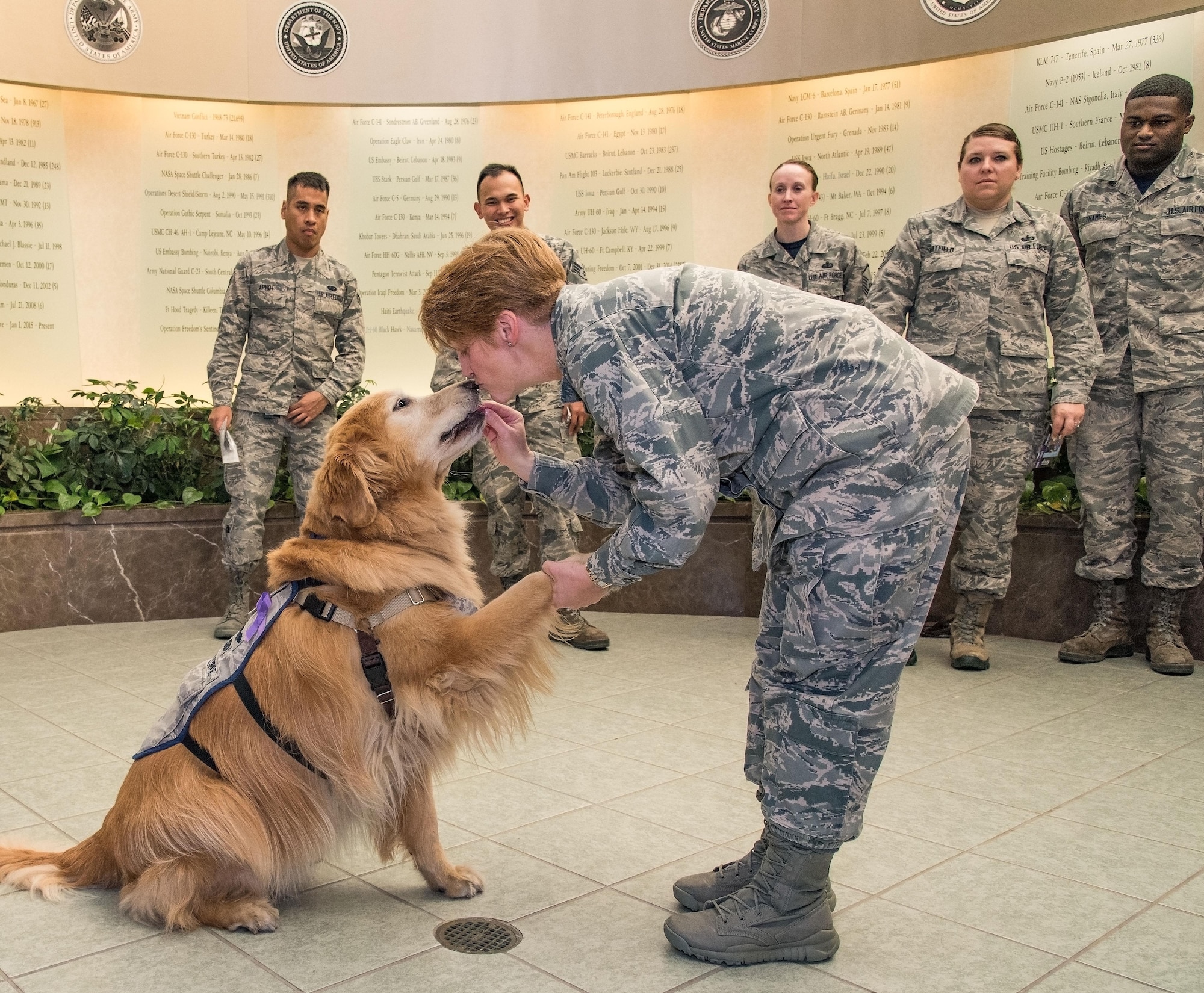 Col. Dawn Lancaster, Air Force Mortuary Affairs Operations commander, gives Lt. Col. Goldie a treat and a kiss on the nose during his visit with AFMAO personnel, Oct. 20, 2017, on Dover Air Force Base, Del. Goldie is a nine-year old Golden Retriever therapy dog stationed at Walter Reed National Military Medical Center, Bethesda, Md., came to the base to be part of the 436th Medical Operations Squadron Family Advocacy’s Domestic Violence Awareness Month outreach. (U.S. Air Force photo by Roland Balik)