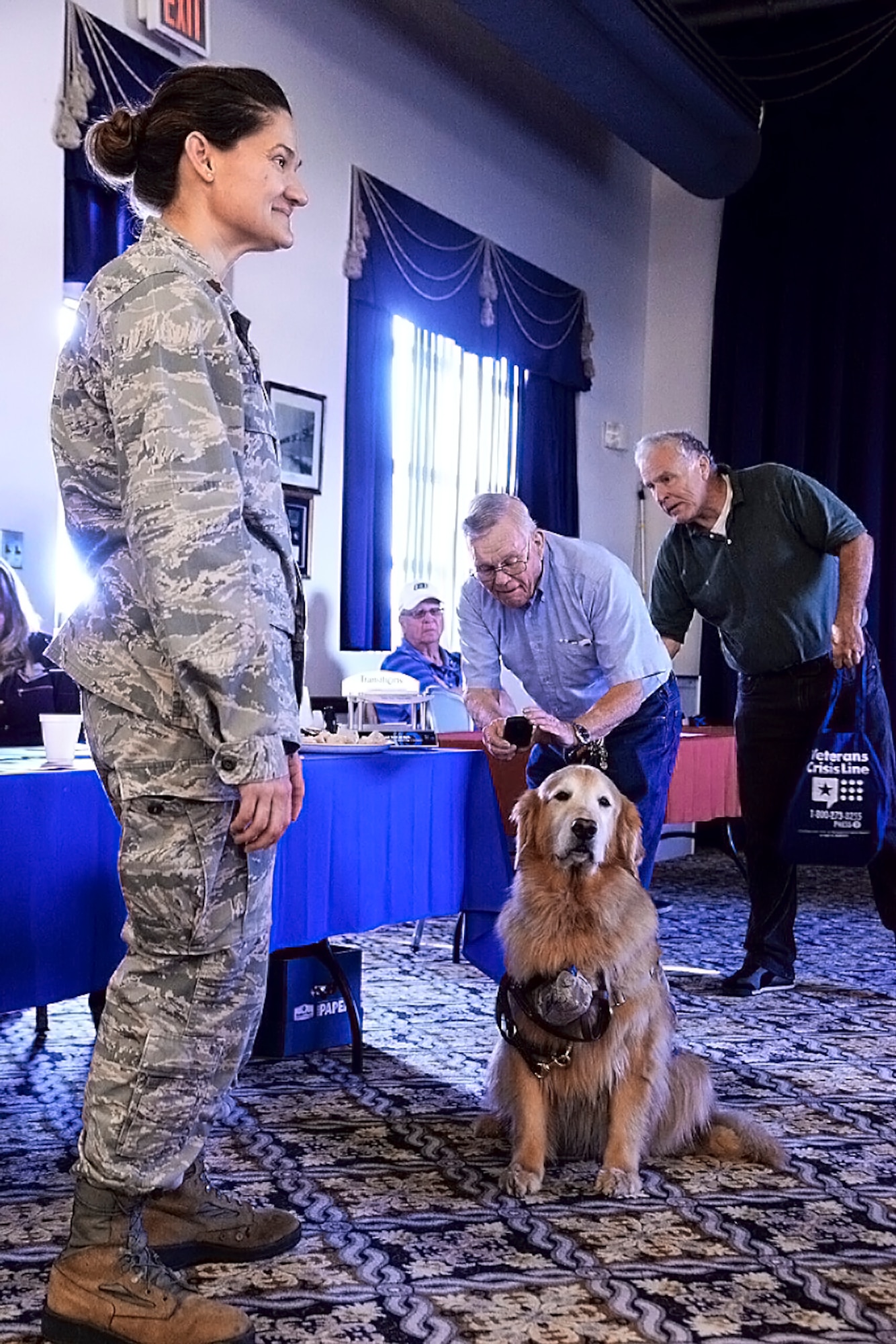 Maj. Regina Owen, 436th Medical Operations Squadron psychiatric mental health nurse practitioner, introduces Lt. Col. Goldie, a nine-year-old Golden Retriever therapy dog stationed at Walter Reed National Military Medical Center, Bethesda, Md., to local area military retirees, Oct. 21, 2017, at The Landings on Dover Air Force Base, Del. As part of Family Advocacy’s outreach during Domestic Violence Awareness Month, Owen and Goldie stopped in during Dover AFB Retiree Day. (U.S. Air Force photo by Tech. Sgt. Matt Davis)