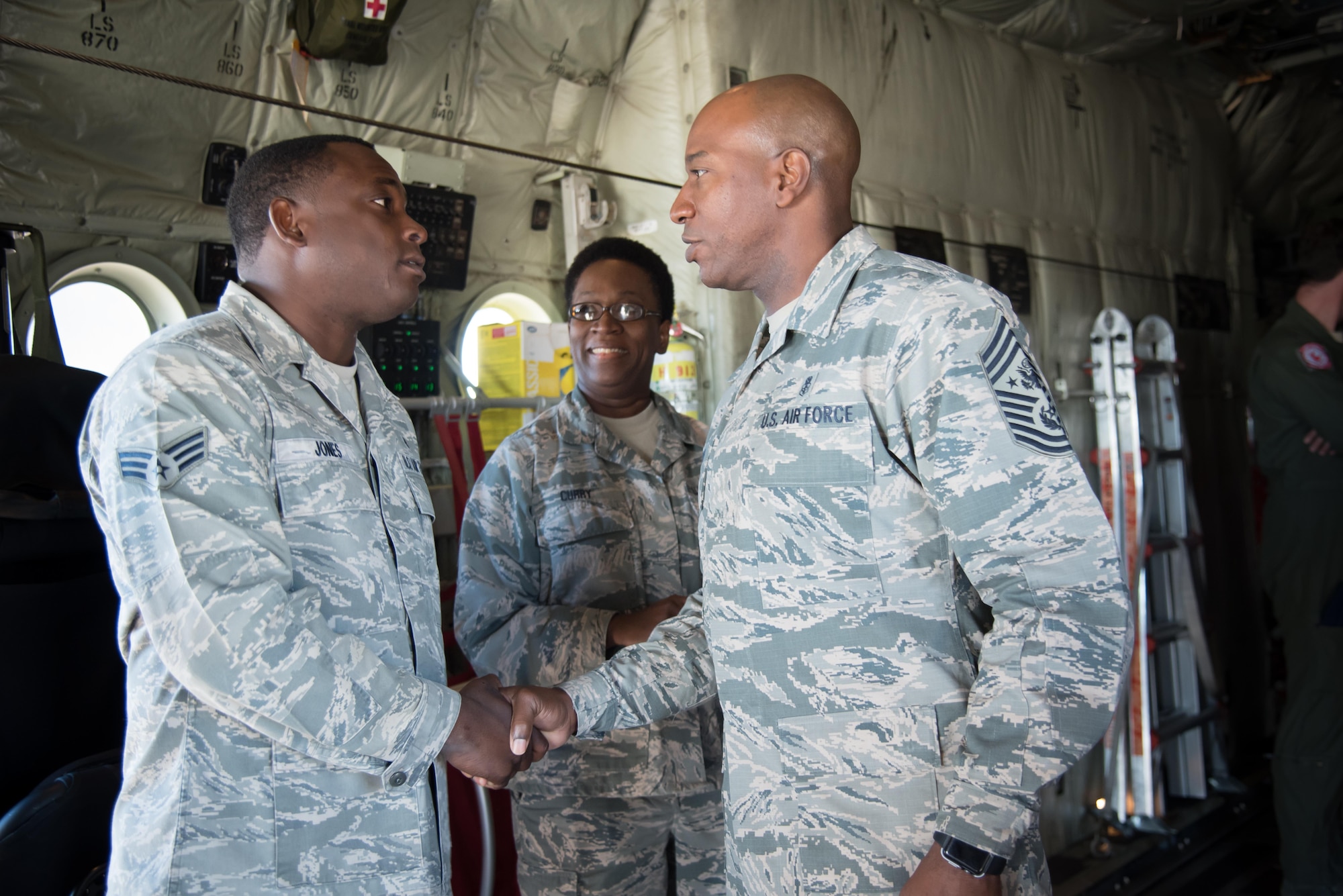 Chief Master Sergeant of the Air Force Kaleth O. Wright presents a coin to Senior Airman Laborian Jones, 403rd Aeromedical Staging Squadron, during his visit to the 403rd Wing Oct. 25, 2017 at Keelser Air Force Base, Mississippi. (U.S. Air Force photo/Staff Sgt. Heather Heiney)