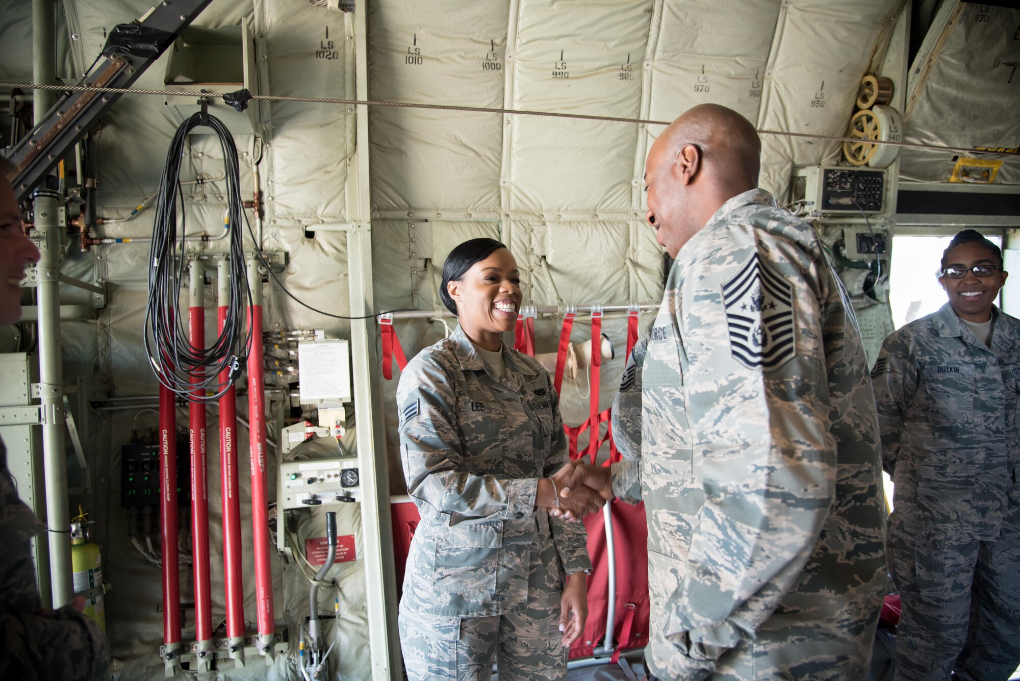 Chief Master Sergeant of the Air Force Kaleth O. Wright presents a coin to Senior Airman Latoya Lee, 403rd Wing Judge Advocate office, during his visit to the 403rd Wing Oct. 25, 2017 at Keelser Air Force Base, Mississippi. (U.S. Air Force photo/Staff Sgt. Heather Heiney)