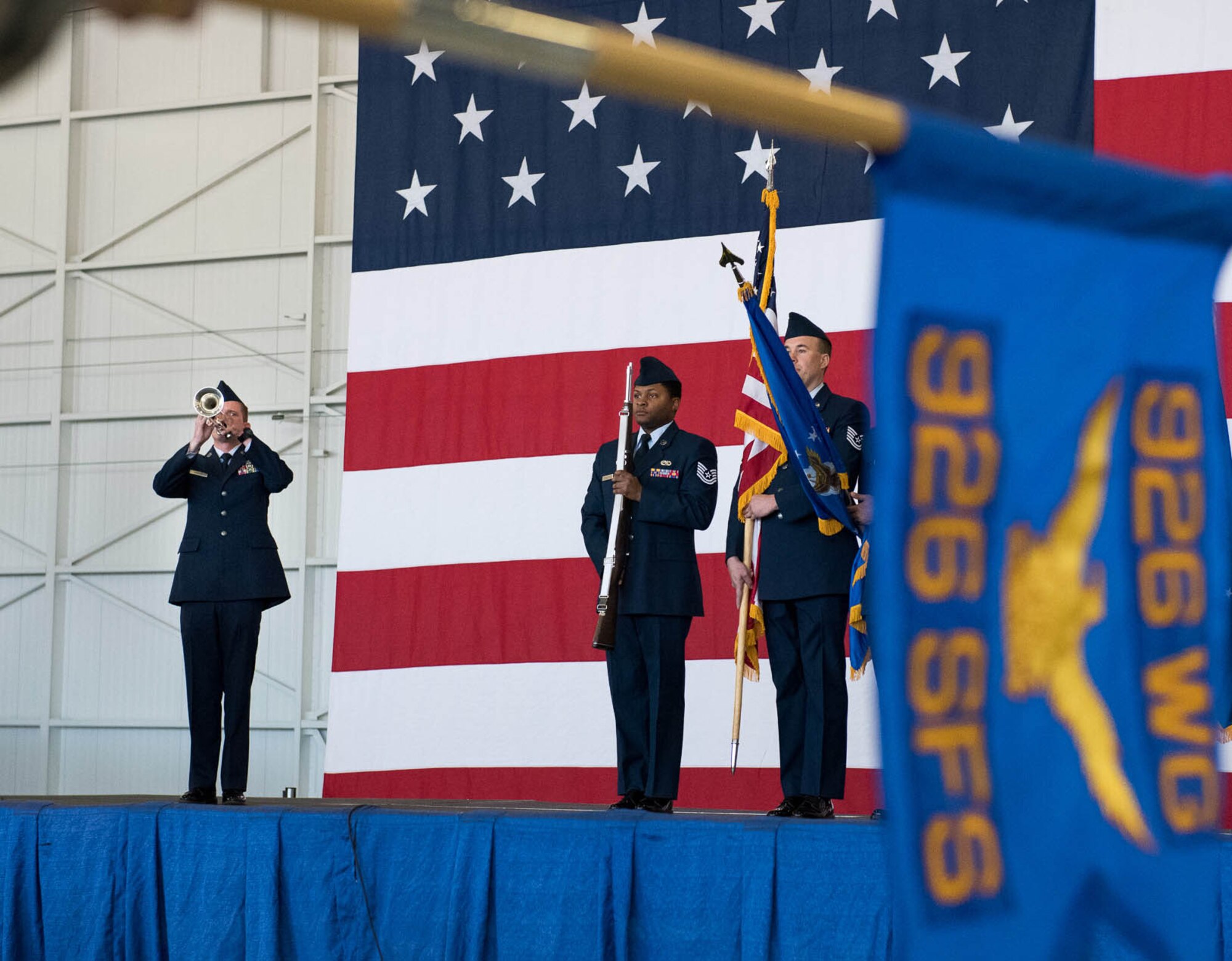 (Left) Tech. Sgt. Johnathon Lavender performs the national anthem on his trumpet as honor guard members present the colors during the 926th Change of Command ceremony on Oct. 14 at the Lightning hangar.