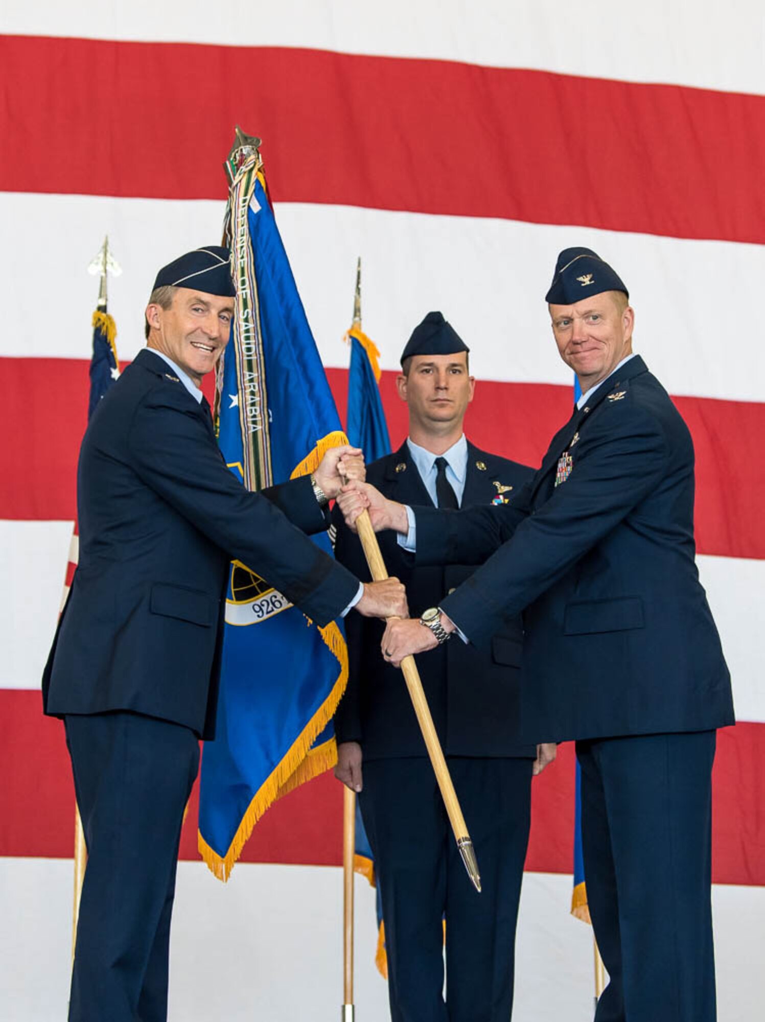 (Right) Col. Michael Schultz, incoming 926th Wing Commander, receives the guidon from Maj. Gen. Ronald Miller, 10th Air Force Commander, during a Change of Command ceremony on Oct. 14 at the Lightning hangar.