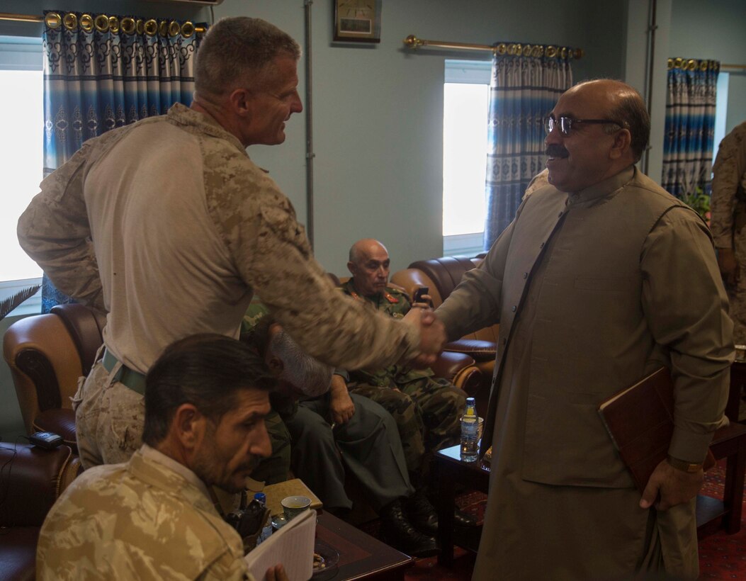 U.S. Marine Brig. Gen. Roger Turner, left, the commanding general of Task Force Southwest, greets Col. Kareem, the Provincial Headquarters G-2, during a key leader engagement at Bost Airfield, Afghanistan, Oct. 15, 2017. Task Force Southwest Marines are assisting their Afghan National Defense and Security Force Counterparts throughout Operation Maiwand Seven through battle tracking and close air support. The mission focuses on clearing the Taliban from the Nad’Ali district in order to expand security around the provincial capital Lashkar Gah while also promoting security and stability for the local populace. (U.S. Marine Corps photo by Sgt. Justin T. Updegraff)
