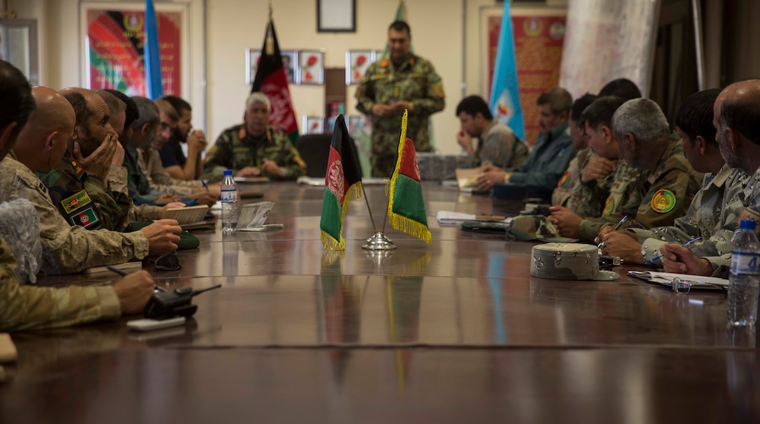 Afghan National Defense and Security Force key leaders and U.S. Marine advisors with Task Force Southwest discuss objectives for the next phase of Operation Maiwand Seven during a synchronization meeting at Bost Airfield, Afghanistan, Oct. 21, 2017.  The meeting solidified objectives, ensured coalition support and allowed the key leaders to go over proper reporting procedures further improving their battle tracking.  Multiple facets of ANDSF have collaborated throughout the operation, and are continuing to clear the Nad’Ali district of Taliban insurgents to promote stability and security for local residents. (U.S. Marine Corps photo by Sgt. Justin T. Updegraff)