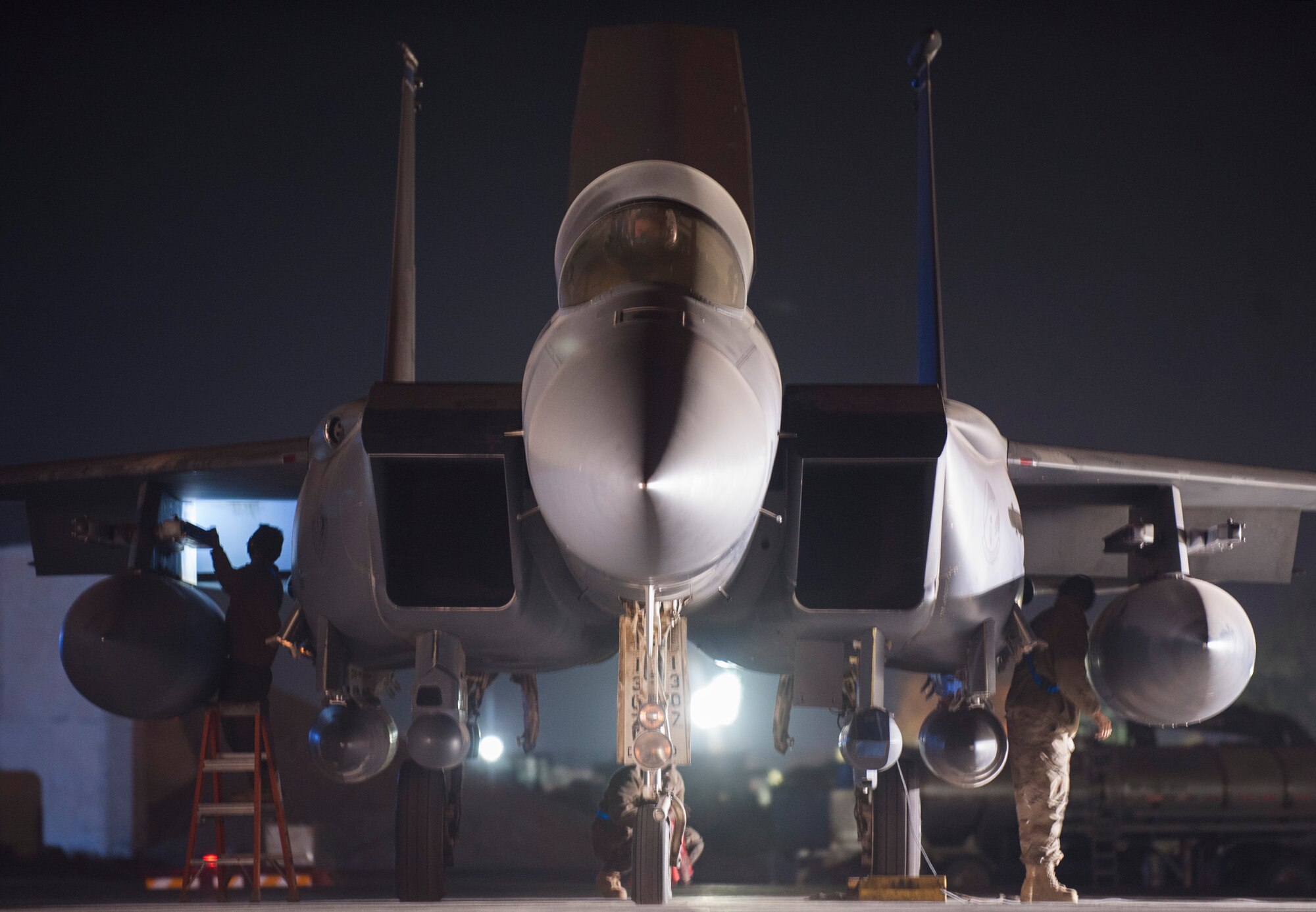 Aircraft maintainers from the 332nd Expeditionary Maintenance Squadron perform pre-flight checks on an F-15E Strike Eagle prior to an early-morning takeoff October 4, 2017, at an undisclosed location in Southwest Asia. Maintenance Airmen work shifts around the clock ensuring aircraft are always available to provide overwatch for Coalition forces and strike targets in support of Operation Inherent Resolve.