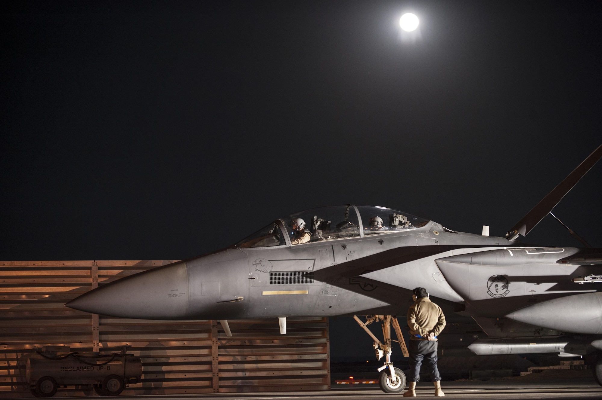 Pilots assigned to the 492nd Expeditionary Fighter Squadron and maintainers from the 332nd Expeditionary Maintenance Squadron finish pre-flight checks on a F-15E Strike Eagle prior to an early-morning takeoff October 4, 2017, at an undisclosed location in Southwest Asia. The 492nd EFS is returning to their home station after six months of relentless strikes against Islamic State forces in the region.
