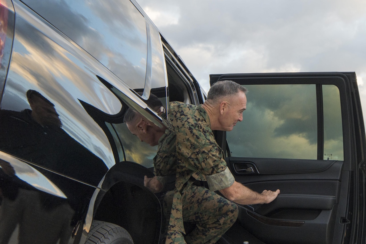 Marine Corps Gen. Joe Dunford exits an SUV.