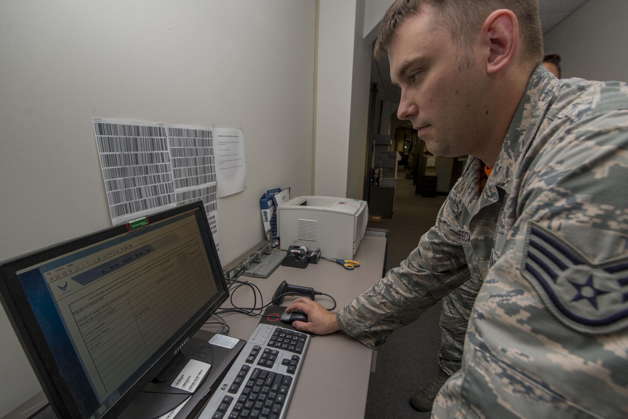 Staff Sgt. Jason Greca, 375th Communications Squadron Client Support Technician, creates a hand receipt for computer equipment being dropped off for repair.