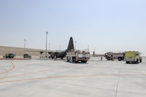 U.S. and Qatar Emiri Air Force firefighters respond to an exercise involving the simulated landing gear failure resulting in simulated casualties aboard a Royal Air Force C-130J Hercules on the runway at Al Udeid Air Base, Qatar, Oct. 3, 2017.