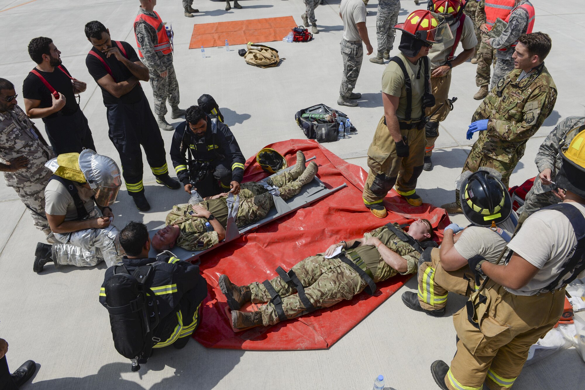 Members of the U.S. Air Force, Royal Air Force, and Qatar Emiri Air Force take part in responding too, and evaluating the response too, a simulated aircraft accident on the runway at Al Udeid Air Base, Qatar, Oct. 3, 2017.
