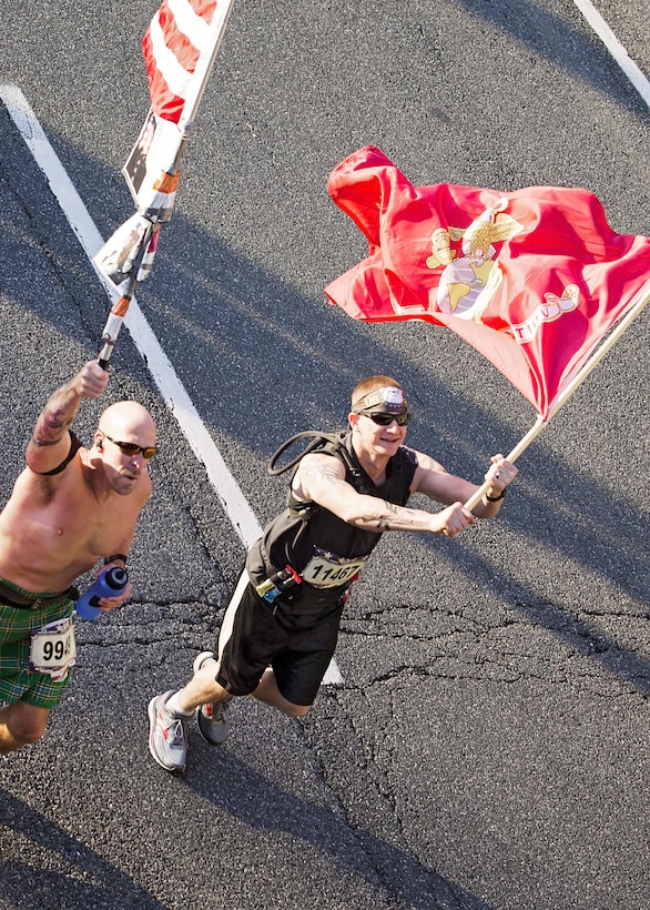 Runners carry the U.S. and Marine Corps flags during the Marine Corps Marathon.