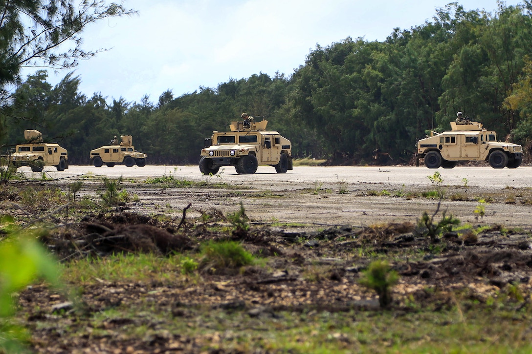 Soldiers provide security atop Humvees during a vehicle mounted patrol training exercise at Andersen Air Force Base, Guam.