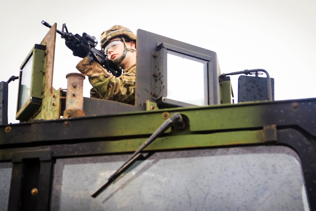 A soldier provides security atop a Humvee during a vehicle mounted patrol training exercise at Andersen Air Force Base, Guam.