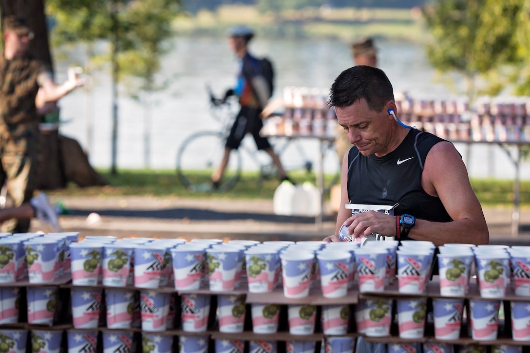 A runner stops for water during the Marine Corps Marathon.