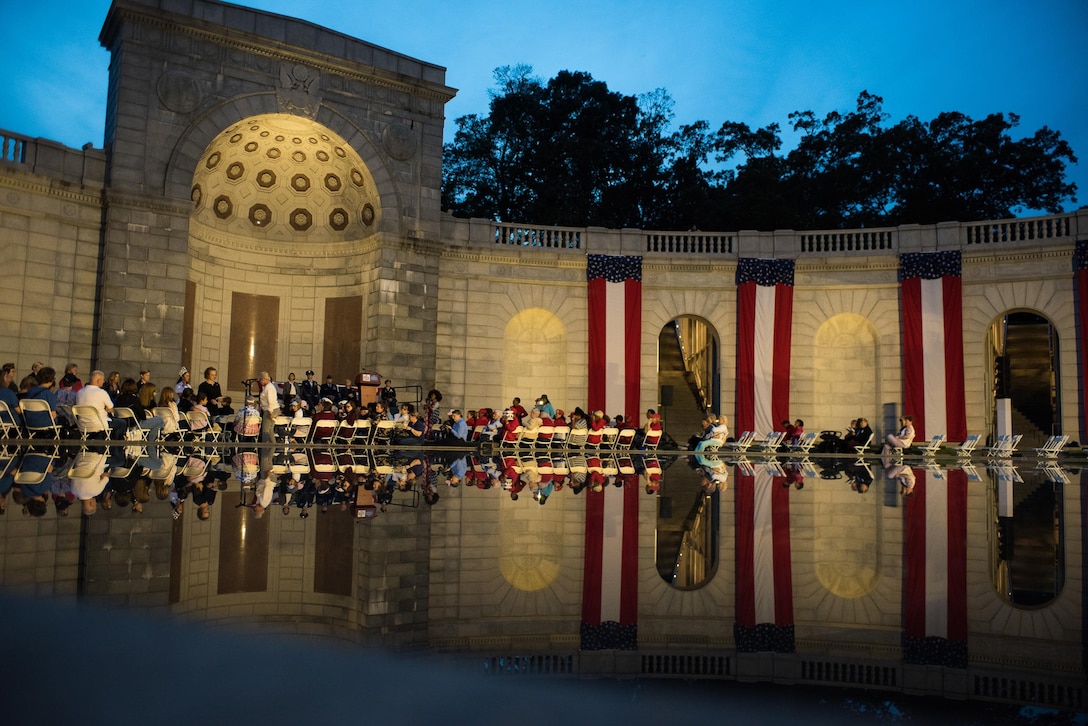 Women toss rose petals into the reflecting pool of the Women in Military Service for America memorial during a ceremony that honored the 15 fallen women of the U.S. Armed Forces since 2012, Oct. 21, 2017, in Washington D.C. Nearly 40 Oklahoma Air and Army National Guard women gathered with hundreds of active-duty, retired and reserve servicewomen from all branches of the military to celebrate the 20th anniversary of the dedication of the Women in Military Service for America Memorial to honor the women who came before them and celebrate the opportunities that are still to come. (U.S. Air National Guard photo by Staff Sgt. Kasey Phipps)