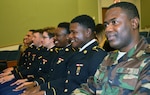 Pfc. Yardy Collins from Monrovia, Liberia, and his fellow classmates wait for the start of the Medical Education and Training Campus preventive medicine specialist graduation ceremony Oct. 20 at Joint Base San Antonio-Fort Sam Houston. Collins is the first international military student from Liberia to graduate from the program.