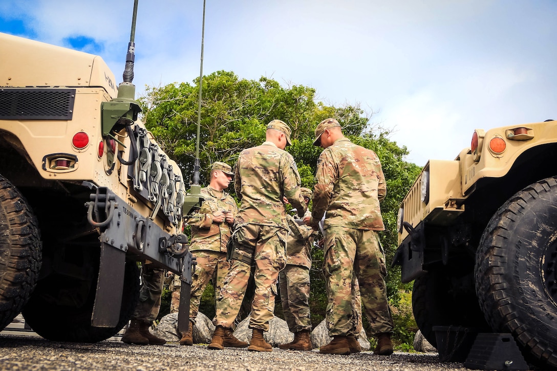 Soldiers discus routes before participating in a vehicle mounted patrol training exercise.