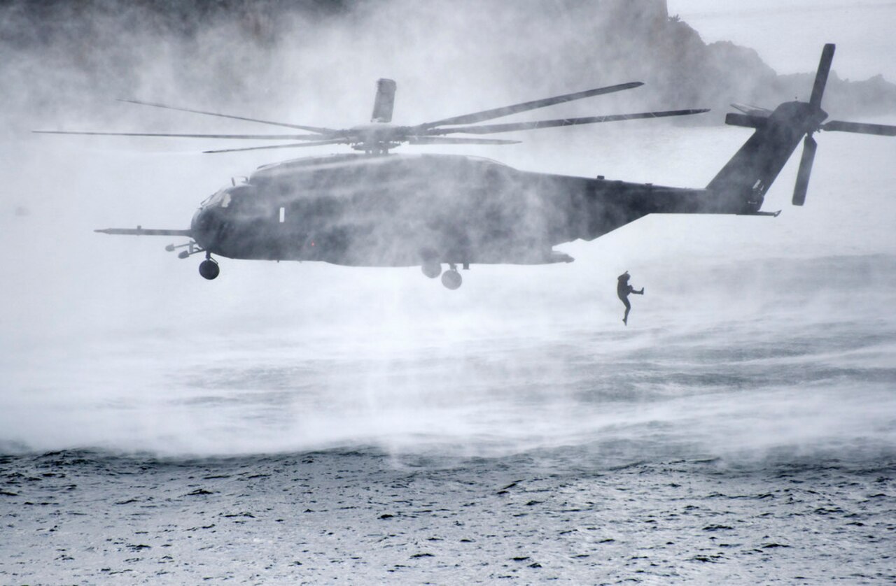 Explosive ordnance disposal divers with the American and South Korean navies exit an MH-53E Sea Dragon helicopter during the annual Multinational Mine Warfare Exercise in Busan, South Korea.