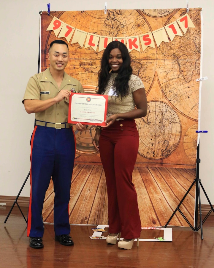 Major Richard Lee, commanding officer of Recruiting Station Tampa, 6th Marine Corps District, presents Staff Sgt. Karen Helms, administration chief with RS Tampa, her certificate of completion for the Lifestyles, Insights, Networking, Knowledge and Skills program’s course aboard MacDill Air Force Base, Tampa, Florida, Oct. 19, 2017. The L.I.N.K.S. program is in its 20th year and serves as a tool that spouses and families in the Marine Corps can use to learn about the military lifestyle.  (Official Marine Corps photo by Sgt. Calvin Shamoon)