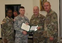 (Left to right) Command Sgt. Maj. Sharon Campbell, Sgt. 1st Class Martin Rhoades, Col. Jay Gilhooly, and Command Sgt. Maj. Jeffrey Darlington pose for photographs as Rhoades receives the 80th Training Command 2017 Instructor of the Year NCO award at the completion of the two-day competition at Fort Knox, Kentucky, Oct. 22, 2017.  Rhoades serves as an instructor for the 94th Training Division-Force Sustainment.