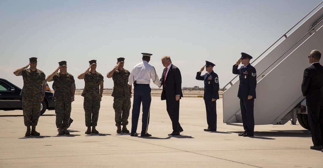 U.S. President Donald J. Trump greets the commanding officers of Marine Corps Air Station (MCAS) Yuma, Ariz., Marine Test and Evaluation Squadron One, Marine Aviation Weapons and Tactics Squadron One, and Marine Aircraft Group 13 on the flightline Aug. 22, 2017. President Trump visited MCAS Yuma to interact with Marines, Sailors and their families on station. (U.S. Marine Corps photo taken by Lance Cpl. Christian Cachola)
