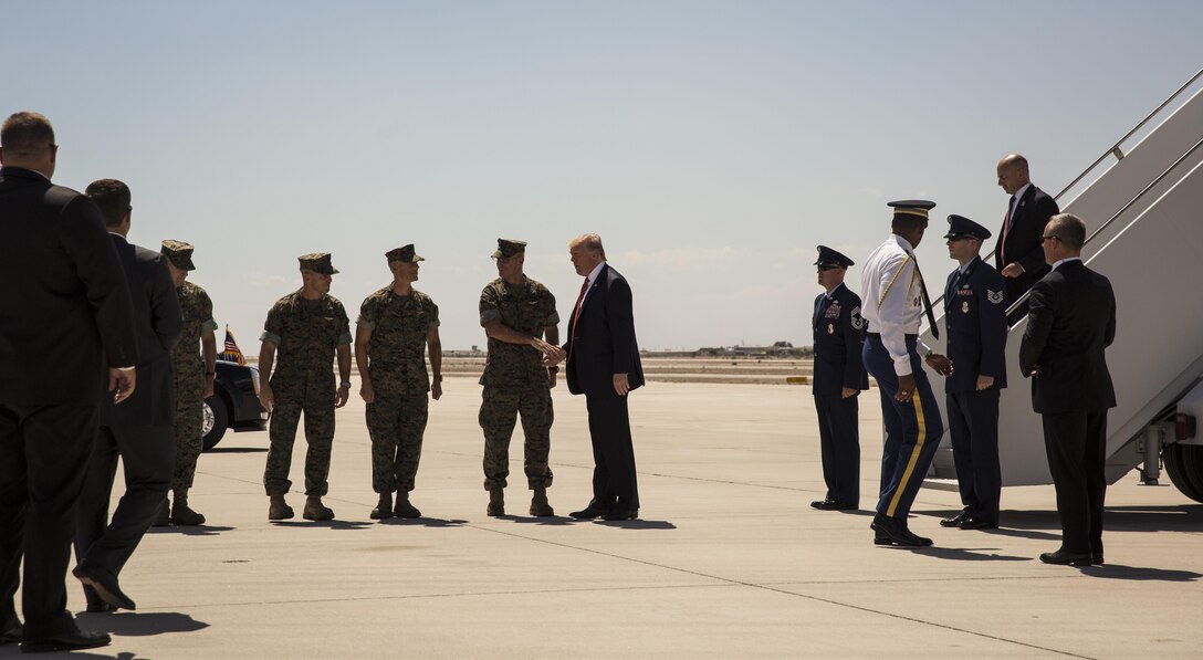 U.S. President Donald J. Trump greets the commanding officers of Marine Corps Air Station (MCAS) Yuma, Ariz., Marine Test and Evaluation Squadron One, Marine Aviation Weapons and Tactics Squadron One, and Marine Aircraft Group 13 on the flightline Aug. 22, 2017. President Trump visited MCAS Yuma to interact with Marines, Sailors and their families on station. (U.S. Marine Corps photo taken by Lance Cpl. Christian Cachola)