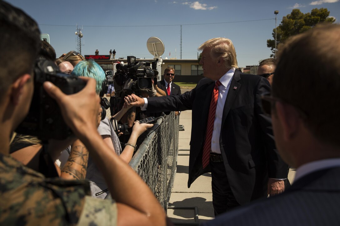 U.S. President Donald J. Trump shakes the hand of a family member during his visit to Marine Corps Air Station (MCAS) Yuma, Ariz., Aug. 22, 2017. President Trump visited MCAS Yuma to interact with Marines, Sailors and their families on station. (U.S. Marine Corps photo taken by Lance Cpl. Christian Cachola)