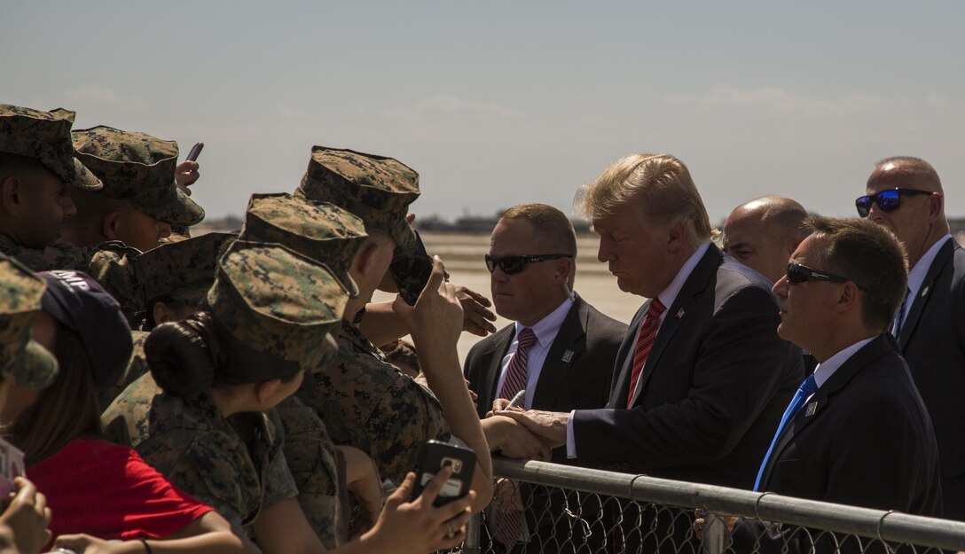 U.S. President Donald J. Trump autographs various Marine memorabilia aboard Marine Corps Air Station (MCAS) Yuma, Ariz., Aug. 22, 2017. President Trump visited MCAS Yuma to interact with Marines, Sailors and their families on station. (U.S. Marine Corps photo taken by Lance Cpl. Isaac D. Martinez)