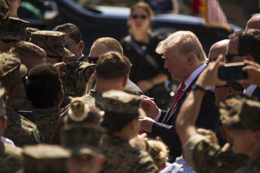 U.S. President Donald J. Trump autographs various Marine memorabilia aboard Marine Corps Air Station (MCAS) Yuma, Ariz., Aug. 22, 2017. President Trump visited MCAS Yuma to interact with Marines, Sailors and their families on station. (U.S. Marine Corps photo taken by Lance Cpl. Isaac D. Martinez)